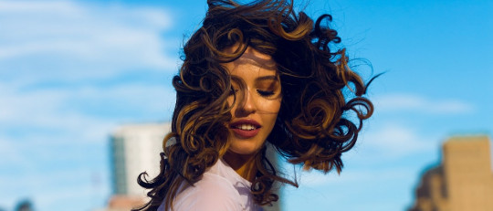 Mujer joven de pelo rizado.