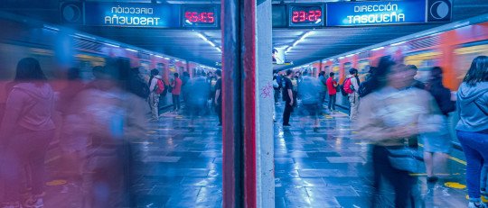 Andén del metro de Ciudad de México con mucha gente esperando y subiendo al tren en hora punta